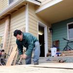 Eutiquio Martinez-Garcia builds a storage shed in the backyard of his home in Monroe. He also constructed the roofs on all 13 townhomes along West Main Street through the Team HomeBuilding program. (Kevin Clark / The Herald)