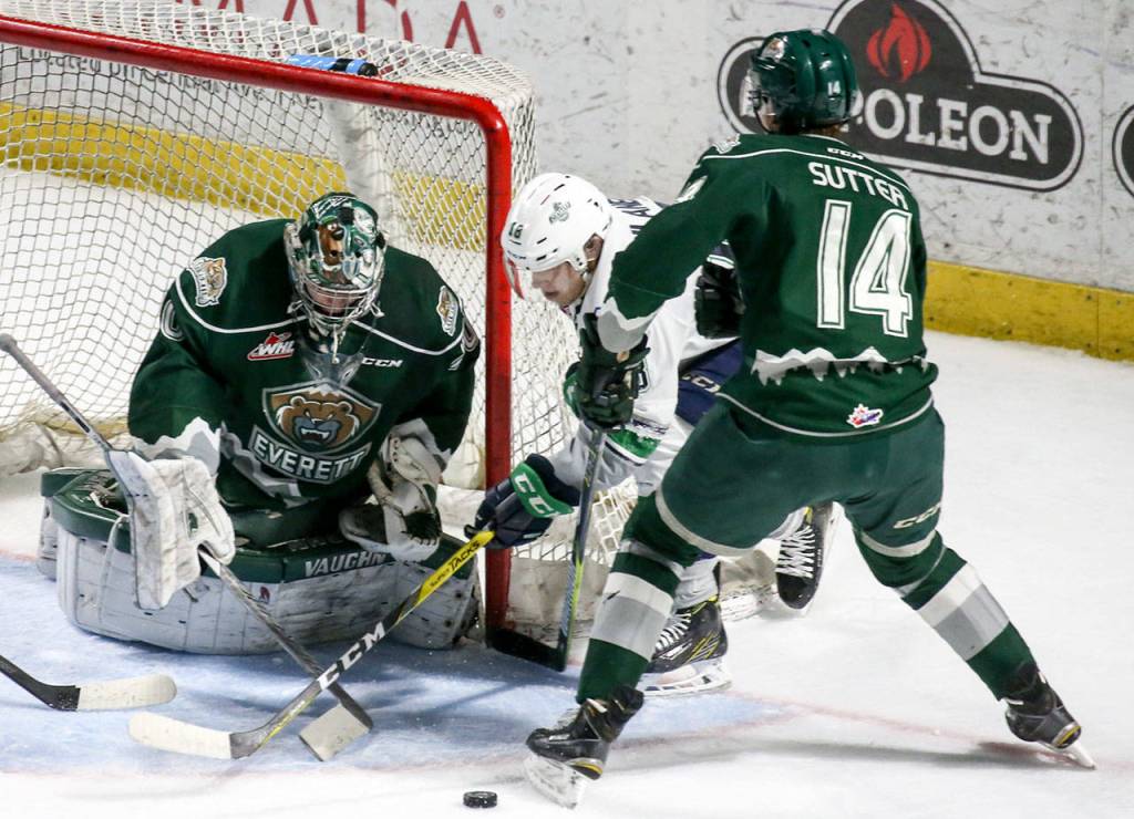 Seattle&rsquo;s Sami Moilanen (center) works a shot attempt past Everett&rsquo;s Carter Hart (left) and Riley Sutter during Game 4 of a second-round playoff series on April 14, 2017, at Showare Center in Kent. (Kevin Clark / The Herald)