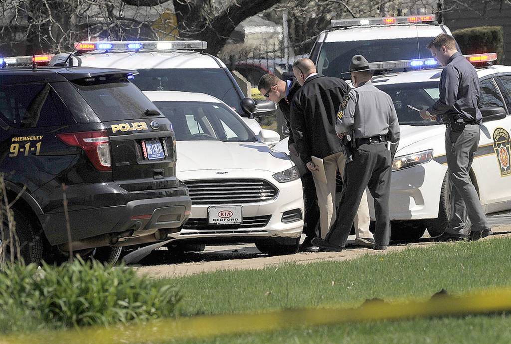 Pennsylvania State Police look over a car as they investigate the scene where Steve Stephens, the suspect in the random killing of a Cleveland retiree posted on Facebook, was found shot dead Tuesday, April 18, in Erie. Pennsylvania. (Greg Wohlford/Erie Times-News via AP)

