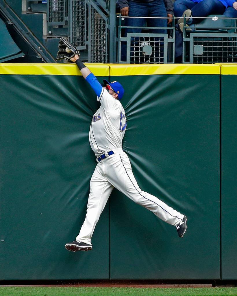 Seattle Mariners center fielder Mitch Haniger makes a leaping catch at the wall to rob Texas Rangers&rsquo; Joey Gallo of a two-run home run with the score tied in the eighth inning, Sunday, April 16, in Seattle. (AP Photo/Ted S. Warren)