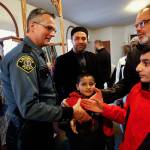 After speaking to a large crowd at the Evergreen Islamic Institute, then-acting Lynnwood Police Chief Tom Davis is greeted warmly by individuals and families earlier this year. Davis spoke on the subject of immigration policy and how the police department and Muslim community can work together. (Dan Bates / The Herald)