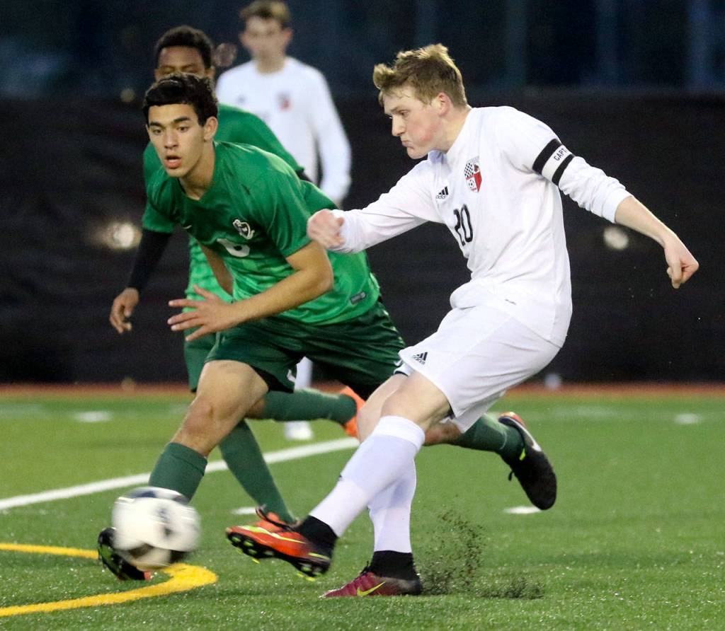 Snohomish&rsquo;s Jason Fairhurst attempts a shot at goal with Edmonds-Woodway&rsquo;s Cameron Cohn defending during a game April 20, 2017, at Memorial Stadium in Snohomish. (Kevin Clark / The Herald)