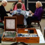 Sitting on a table in the center of the room, two hand-crafted cedar boxes hold card decks and other important materials used in playing bridge. They were made by long-time club member John Marchetti, 99, of Everett. (Dan Bates / The Herald)