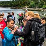 Last year&rsquo;s Madison Elementary School fifth-graders and accompanying staff experience the joy in finding such things as even a tiny crab along the rocky shoreline at Camp Orkila on Orcas Island. (Courtesy Madison Elementary School)