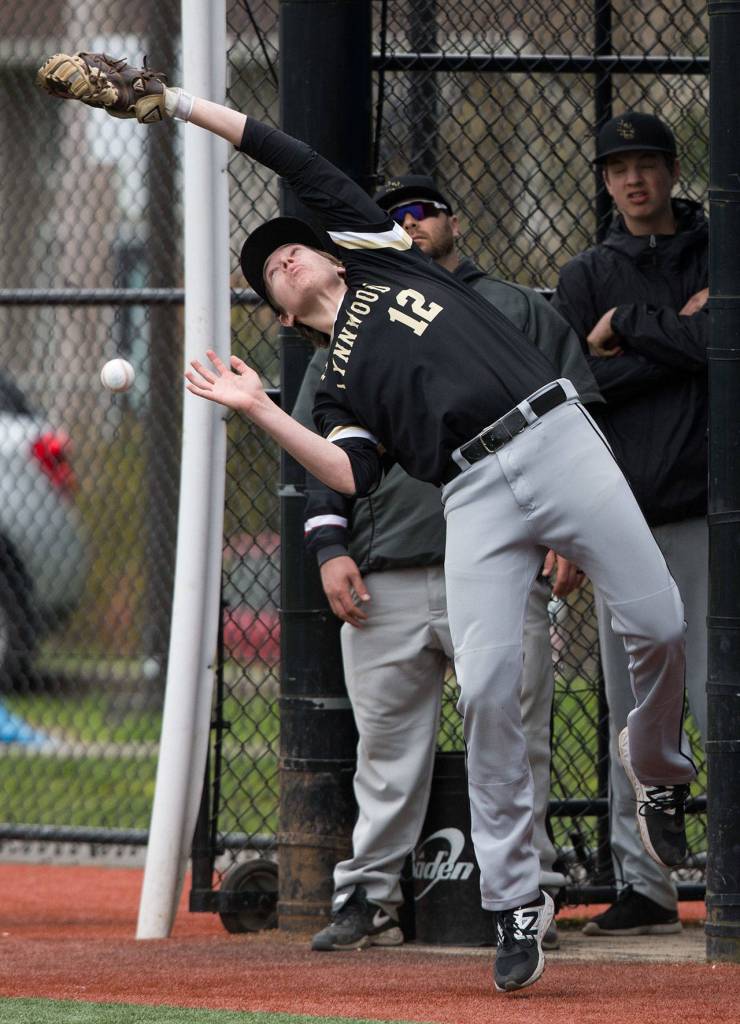Lynnwood&rsquo;s Carson Speegle tries to catch a foul ball near the dugout. Lynnwood beat Shorewood 3-2 in nine innings of baseball on Tuesday, April 4, 2017 in Shoreline, Wa. (Andy Bronson / The Herald)