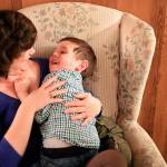 Deanna Fisher tickles her youngest autistic son, Colin, 4, at their home in Bothell. (Kevin Clark / The Herald)
