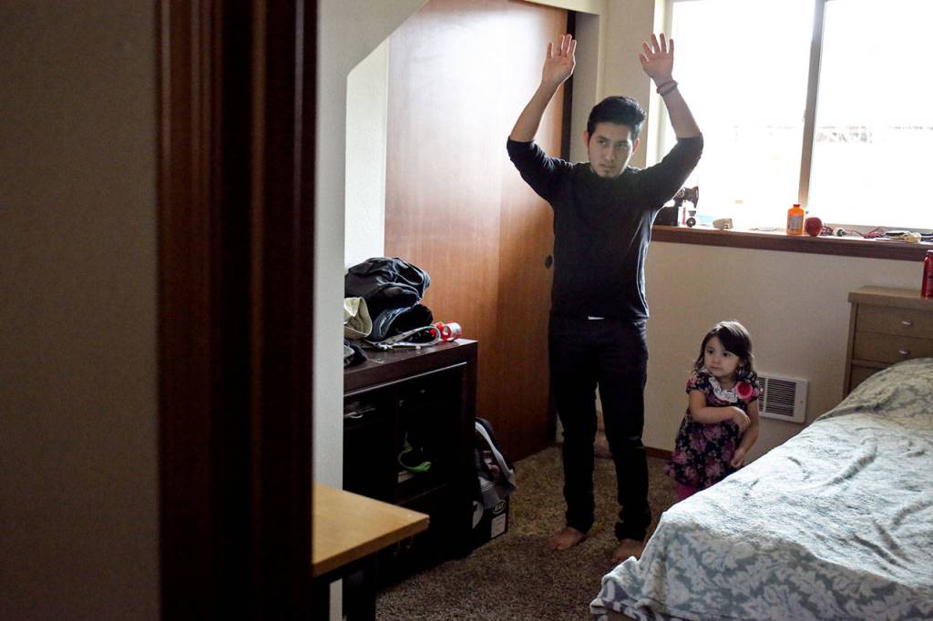 Ernesto Martinez-Hernandez, left, and his little sister Maritza dance along with a video game at their home in Monroe.                                (Kevin Clark / The Herald)