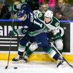 The Thunderbirds&rsquo; Tyler Adams (front) fends off the Silvertips&rsquo; Connor Dewar in the first period during Game 2 of their playoff series on April 8, 2017, at Xfinity Arena in Everett. (Kevin Clark / The Herald)