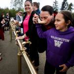 Theresa Sheldon takes a sip of water from a handcarved spoon with the help of her 11-year old, Klayton. (Ian Terry / The Herald)