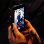 With a cellphone camera, a man records then-acting Lynnwood Police Chief Tom Davis speaking at the Evergreen Islamic Institute earlier this year. (Dan Bates / The Herald)