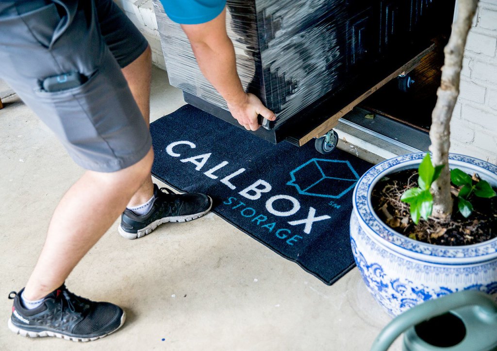 Callbox Storage storage professional Jacob Huttash moves a dresser over a Callbox Storage doormat Oct. 4 at a client&rsquo;s home in Dallas. (Ashley Landis/The Dallas Morning News/TNS)