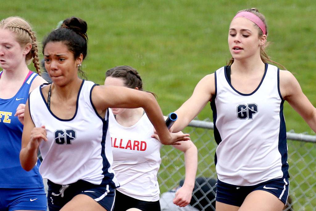 Glacier Peak&rsquo;s Lena Agnew (right) hands off to teammate Tamia DeSchmidt in the 4x100-meter relay during the Eason Invitational on April 22, 2017, at Veteran&rsquo;s Memorial Stadium in Snohomish. (Kevin Clark / The Herald)