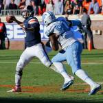 Virginia quarterback Kurt Benkert (6) makes a toss as North Carolina defensive tackle Nazair Jones (90) closes in during the first half of a game Oct. 22, 2016, in Charlottesville, Va. (AP Photo/Steve Helber)