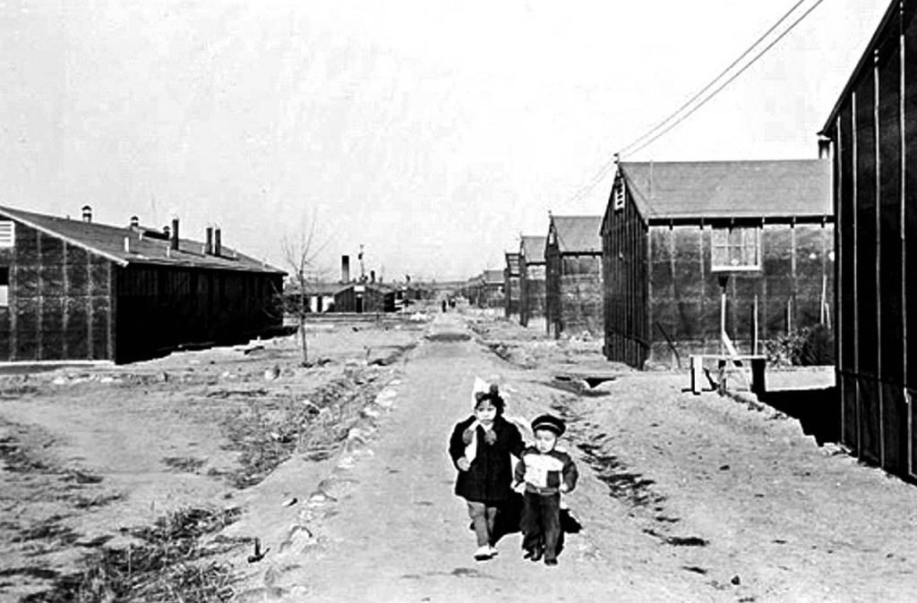 Two children at the Minidoka War Relocation Center, a Japanese internment camp the U.S. government operated in southcentral Idaho during World War II. Cascade High School recently hosted Atsushi Kiuchi, 87, who spent time at Minidoka as a young man. (National Archives photos)