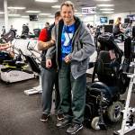 With help from his assistant Duitsman stands up from his wheelchair after exercising on special equipment Wednesday at the Marysville YMCA. (Dan Bates / The Herald)