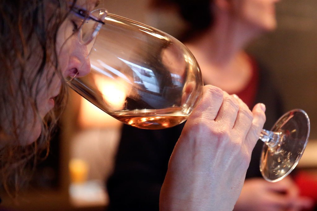 A wine-taster checks the aroma of the wine available at Dusty Cellars Winery on Camano Island on Feb. 4. (Kevin Clark / The Herald)
