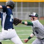 Edmonds-Woodway&rsquo;s Kosta Cooper tags out Meadowdale&rsquo;s Hunter Shouse at Mountlake Terrace High School on April 12. (Kevin Clark / The Herald)