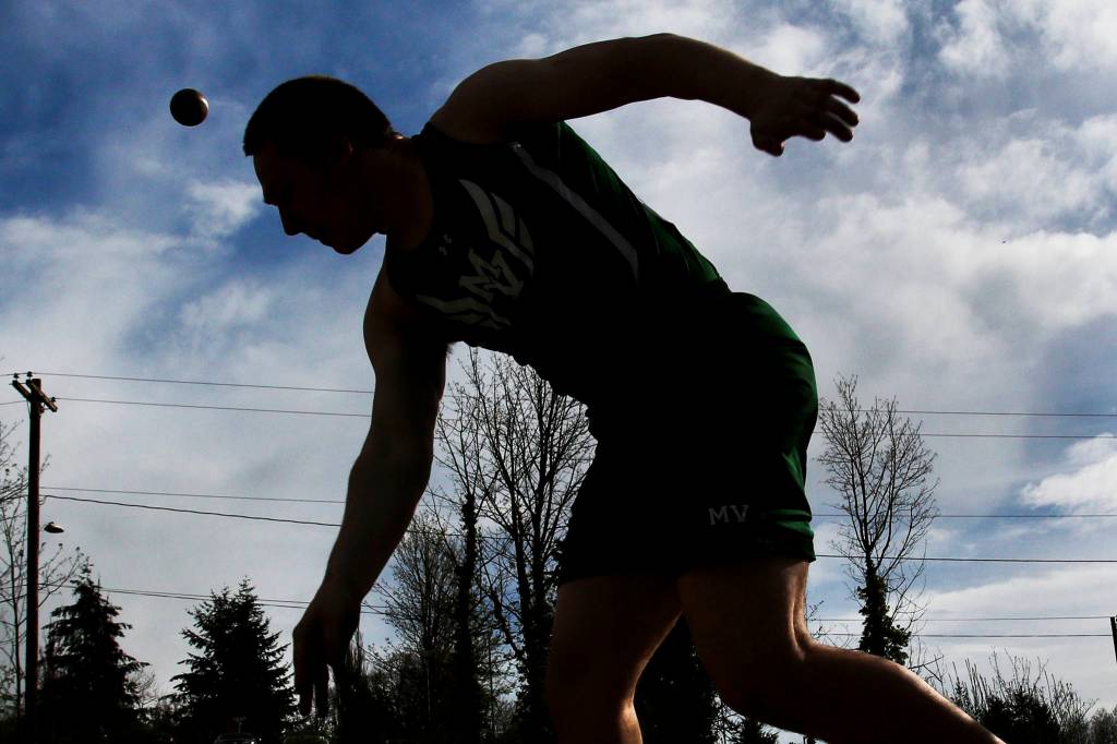 Mount Vernon&rsquo;s Blaine Plessner throws the shot put at Everett Memorial Stadium on April 13. (Kevin Clark / The Herald)