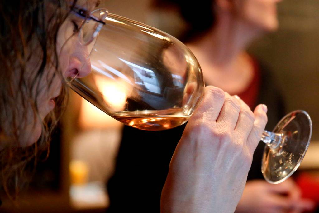 A wine taster checks the aroma of the wine available at Dusty Cellars on Camano Island on Feb. 4. (Kevin Clark / The Herald)