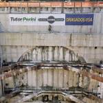 A worker stands on a ledge above a circular, five-foot deep concrete wall where a massive tunnel machine is expected to break through the next day as it completes boring for the State Route 99 highway, Monday, April 3, under Seattle. Bertha, the machine digging a 1.75 mile tunnel under Seattle to replace a waterfront bridge with an underground roadway, is reaching the end of its journey. (AP Photo/Elaine Thompson)