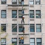 Construction workers assemble scaffolding during renovations on an office building in downtown Washington on Friday. (AP Photo/Pablo Martinez Monsivais)