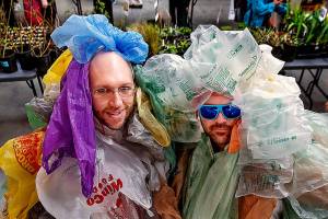 As part of Earth Week, Dan Bauer (left) and William Frankhouser, aka &ldquo;Bagfoot(s),&rdquo; each wear 550 plastic bags, the average number a single human tosses out each year, during Everett Community College&rsquo;s annual plant swap at Whitehorse Hall on Tuesday. When the baggy duo are working, they are part of the college&rsquo;s IT team. (Dan Bates / The Herald)
