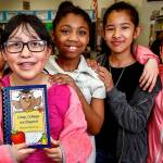 Along with their Madison Elementary School classmates, Jaedin Chum (left), Alfonso Moreno, Jaimy Moreno, Jaila Snowden, Daisy Padilla and Julissa Lopez are selling cookbooks with recipes from their teachers and parents to help pay their way to Camp Orkila on Orcas Island for fifth-grade outdoor camp. Jaimy Moreno, holding the cookbook (center), is tied with one other fifth-grader in sales thus far. (Dan Bates / The Herald)