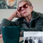 Everett&rsquo;s Doris Sinclair, 88, reflects on a chilling experience she had while traveling by train from Iran to Soviet Georgia in 1964. Detained by Soviet authorities, she was interrogated for three days before being allowed to continue with her trip. Sinclair and her husband, who was in the U.S. Air Force, lived in Iran from 1963 to 1968. In the foreground is a photo of several men in Iran, one of whom was her driver in those years. (Dan Bates / The Herald)