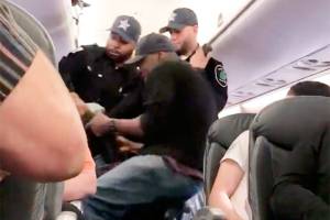 Video: Man dragged off overbooked airplane; outrage ensues