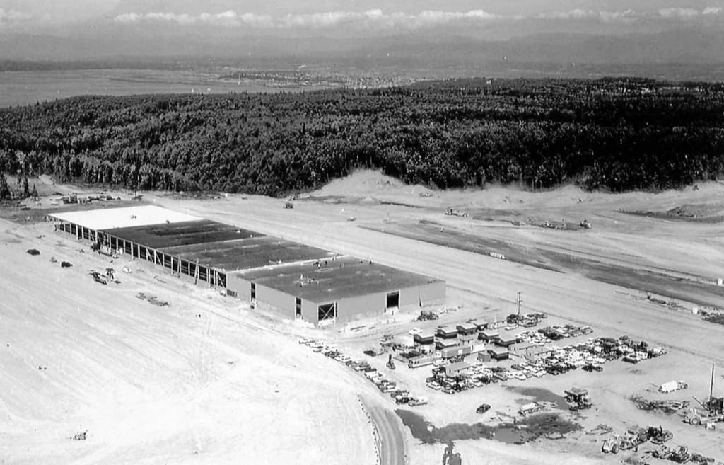 Dozens of cars and a new building under construction at Paine Field, date unknown. Local officials pledged to do whatever was needed to land the factory, which Boeing expected would employ about 15,000 people. Today, roughly 40,000 people work at the sprawling plant and office buildings.