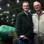 Darin Mang (left), a sparekitting engineer, and his father, Calvin Mang, a retired Boeing engineer, pose in the 747 bay at the Everett plant in 2006. Calvin worked on the original Boeing 747. (Kevin Nortz / The Herald)