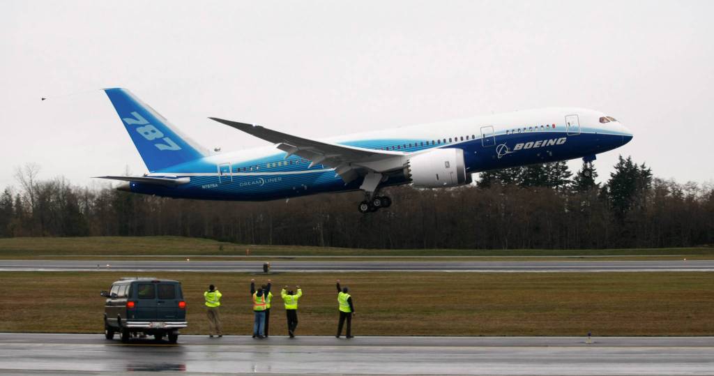 Workers cheer and wave as Boeing&rsquo;s 787 Dreamliner takes off from Paine Field on Dec. 15, 2009. (Justin Best / The Herald