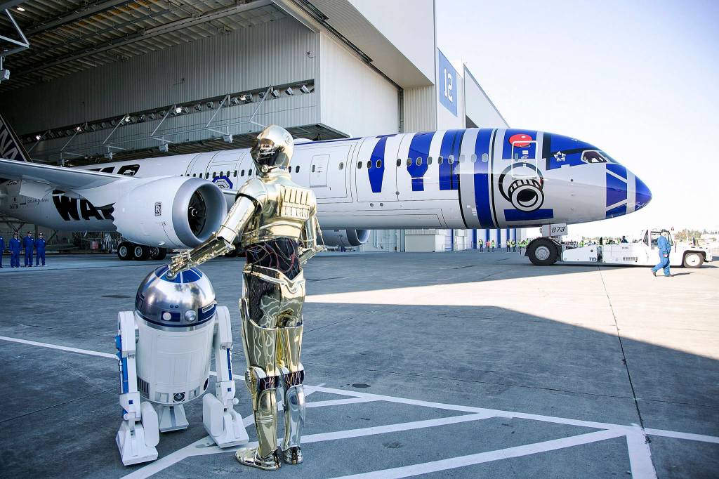R2-D2 and C-3PO watch the unveiling of the R2-D2 themed 787 at Paine Field on Sept. 12, 2015. (Kevin Clark / The Herald)