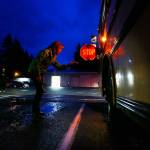Bus driver Carol Mitzelfeldt checks her school bus, its stop paddle extended, before leaving on her route for the Arlington School District on an October morning in 2014. The Marysville School District recently had cameras installed on 15 of its buses that record the license plates of vehicles that illegally pass stopped buses. Fines are then sent to vehicle owners. (Mark Mulligan / Herald file photo)