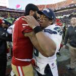 Quarterback Colin Kaepernick hugs Seattle Seahawks quarterback Russell Wilson after a Jan. 1 game in Santa Clara, Calif. (AP Photo/Marcio Jose Sanchez)