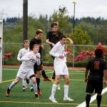 Snohomish&rsquo;s Logan Stapleton (center) and Matt Dobmeier (center left) go up for a header during a first round 3A state playoff game on May 16, 2017, at Snohomish High School. Snohomish won 5-2. (Ian Terry / The Herald)