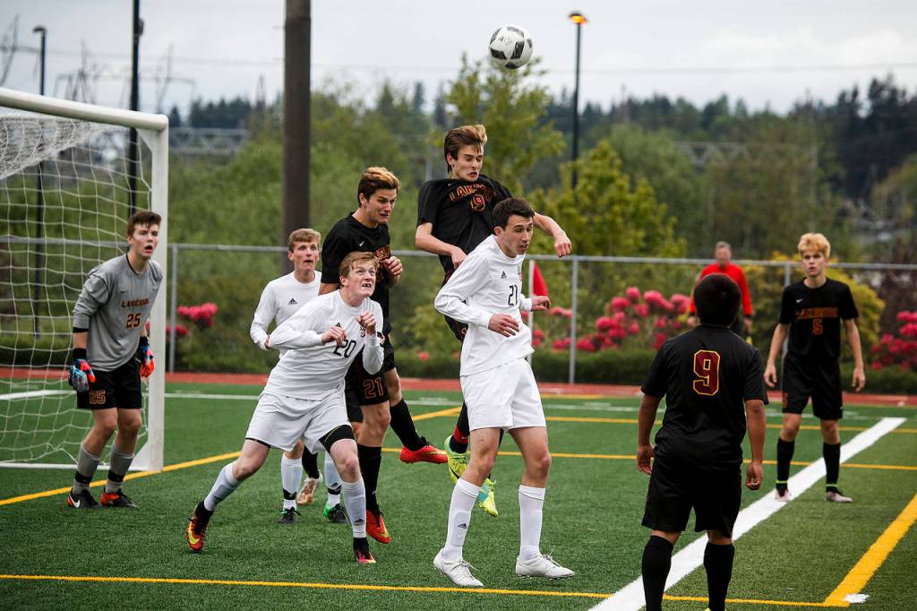 Snohomish&rsquo;s Logan Stapleton (center) and Matt Dobmeier (center left) go up for a header during a first round 3A state playoff game on May 16, 2017, at Snohomish High School. Snohomish won 5-2. (Ian Terry / The Herald)