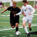 Snohomish&rsquo;s Alex Stigenga (right) brings the ball past Lakeside&rsquo;s Nolan Kim during a first round 3A state playoff game on May 16, 2017, at Snohomish High School. Snohomish won 5-2. (Ian Terry / The Herald)