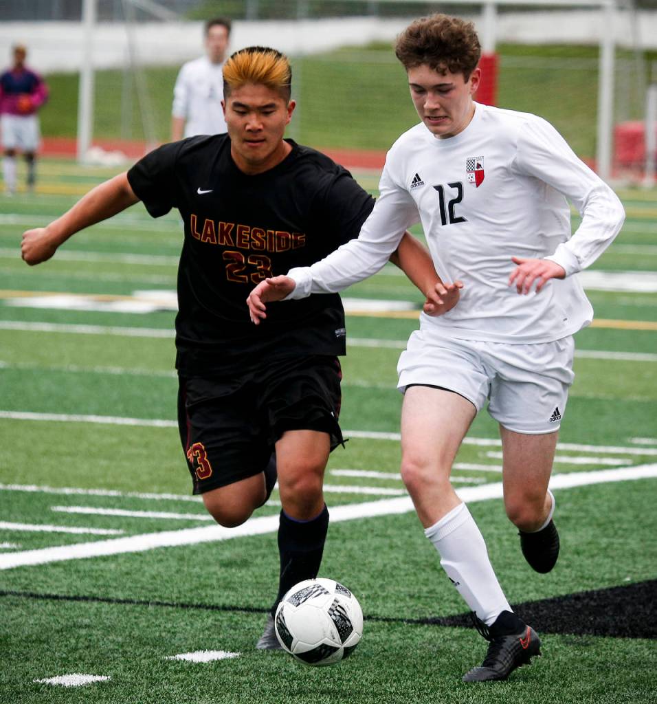 Snohomish&rsquo;s Alex Stigenga (right) brings the ball past Lakeside&rsquo;s Nolan Kim during a first round 3A state playoff game on May 16, 2017, at Snohomish High School. Snohomish won 5-2. (Ian Terry / The Herald)