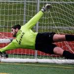 Lynnwood goalkeeper Tyler Stull makes a diving attempt to stop a penalty shot goal during a first-round state 3A playoff game against Roosevelt at Edmonds Stadium on May 17. (Ian Terry / The Herald)