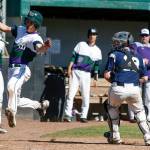 Edmonds-Woodway&rsquo;s Julian Kodama (left) skirts around Arlington catcher Tristan Sheward during a 3A state playoff game on May 20, 2017, at Dream Field in Mount Vernon. (Ian Terry / The Herald)