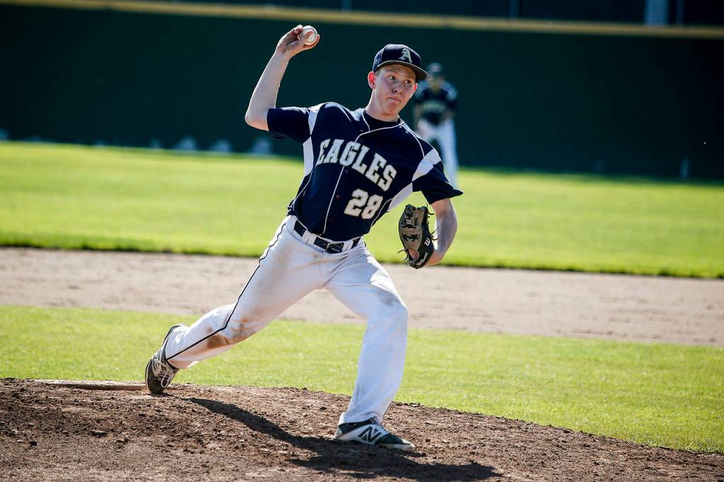 Arlington starting pitcher Owen Bishop delivers a pitch during a 3A state playoff game against Edmonds-Woodway on May 20, 2017, at Dream Field in Mount Vernon. (Ian Terry / The Herald)