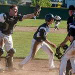 Edmonds-Woodway catcher Garrison Krohn (left) looks for a call from the umpire as Arlington&rsquo;s Trevor Kazen (center) slides in safely to home plate during a 3A state playoff game on May 20, 2017, at Dream Field in Mount Vernon. (Ian Terry / The Herald)