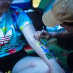 Haley Irving paints designs on her friend Olivia Caron-Noble on the first of three days during the annual Sasquatch! Music Festival on Friday, May 26, 2017 in George, Wa. (Daniella Beccaria / For the Herald )