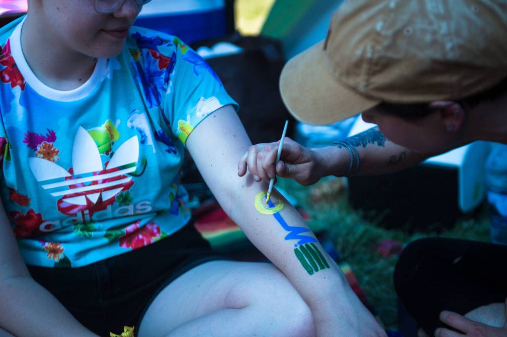Haley Irving paints designs on her friend Olivia Caron-Noble on the first of three days during the annual Sasquatch! Music Festival on Friday, May 26, 2017 in George, Wa. (Daniella Beccaria / For the Herald )