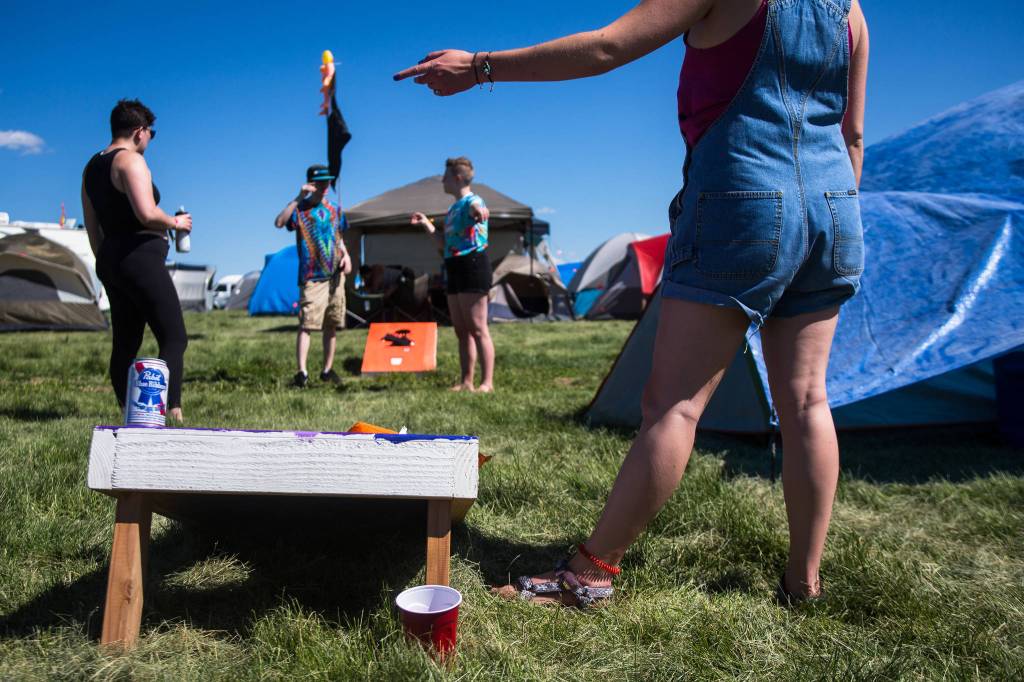 Festivalgoers play a round of corn hole on the first of three days during the annual Sasquatch! Music Festival on Friday, May 26, 2017 in George, Wa. (Daniella Beccaria / For the Herald )