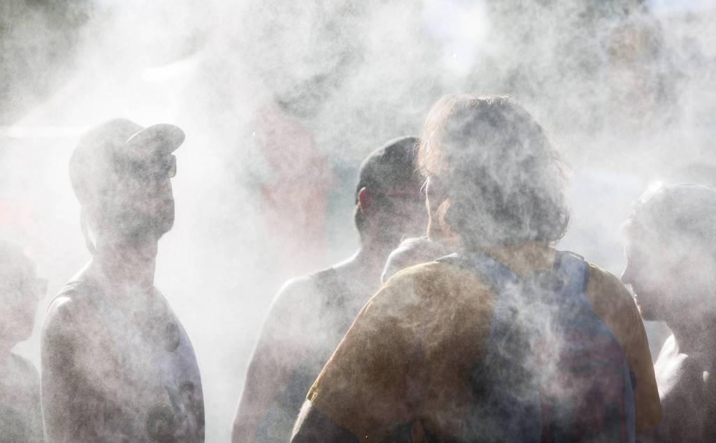 Festivalgoers cool off in the mist on the first of three days during the annual Sasquatch! Music Festival on Friday, May 26, 2017 in George, Wa. (Daniella Beccaria / For the Herald )