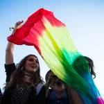 Festival-goers dance with a rainbow tie-dye flag at the Bigfoot stage on the first of three days during the annual Sasquatch! Music Festival on Friday, May 26, 2017 in George, Wa. (Daniella Beccaria / For the Herald )