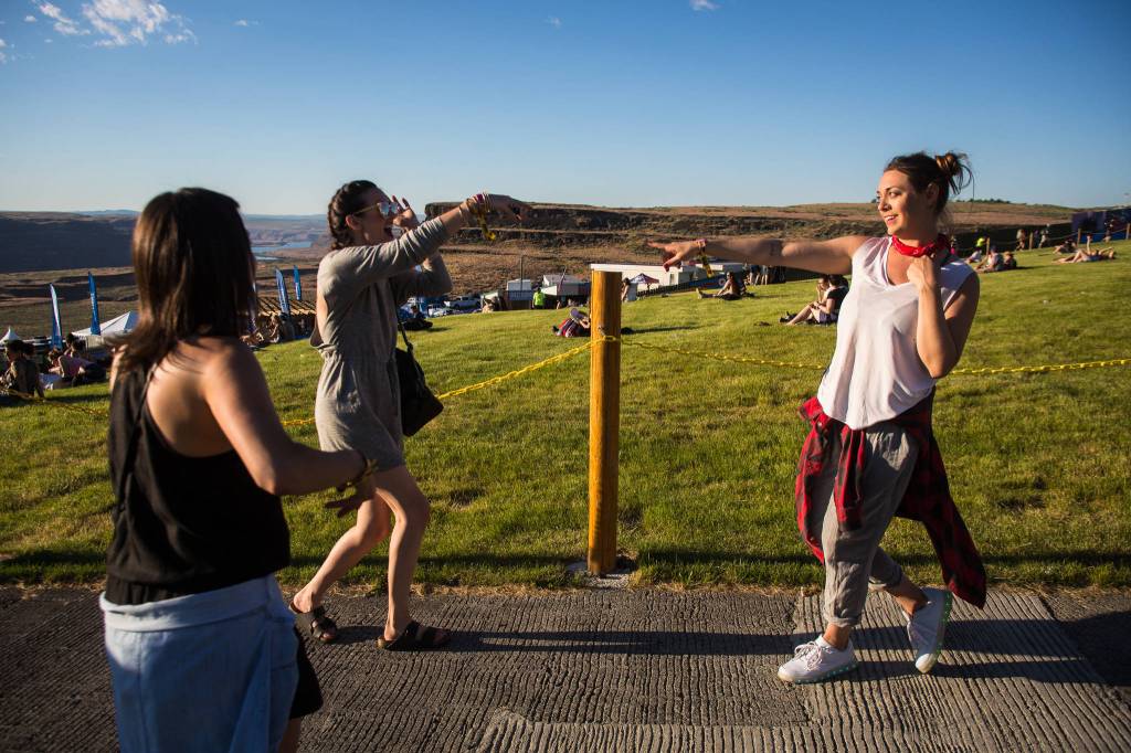 Kristina Dziedzic (right) points to her friend Liz Todd while dancing near the main stage on the first of three days during the annual Sasquatch! Music Festival on Friday, May 26, 2017 in George, Wa. (Daniella Beccaria / For the Herald )
