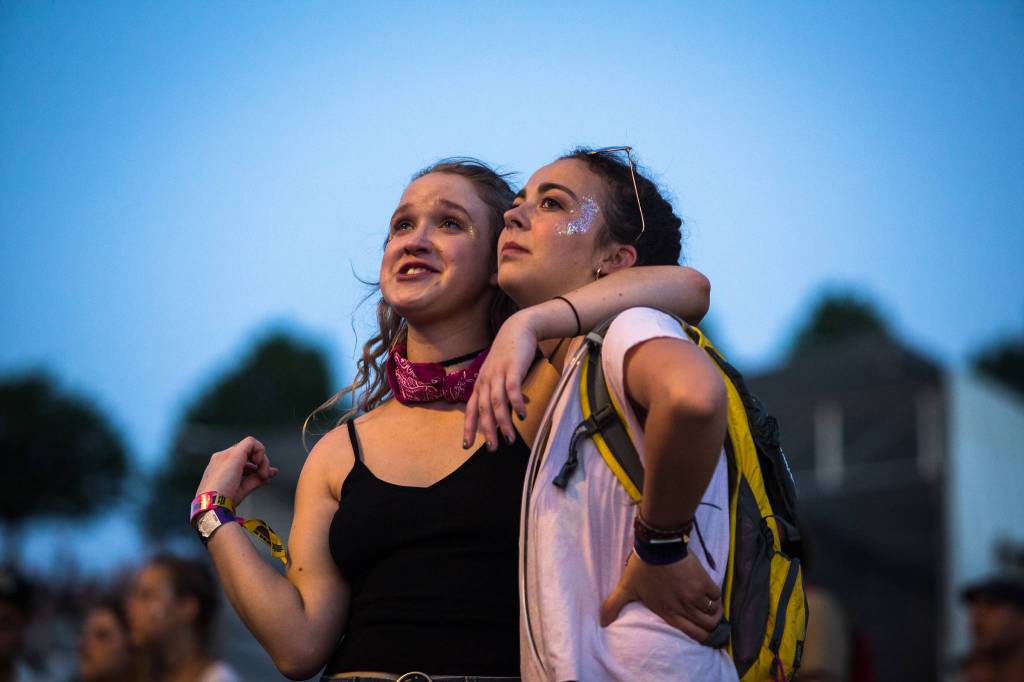 A girl and her friend watch The Head and the Heart perform at the main stage on the first of three days during the annual Sasquatch! Music Festival on Friday, May 26, 2017 in George, Wa. (Daniella Beccaria / For the Herald )